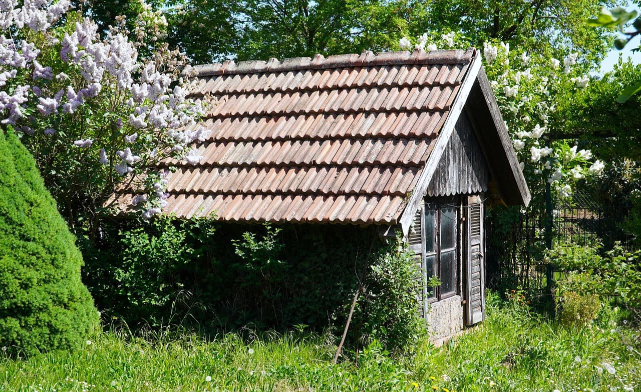 Professional shed removal team demolishing and removing an old shed structure